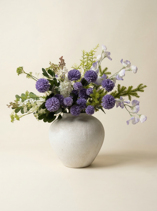 Floral arrangement in a white vase on a beige background