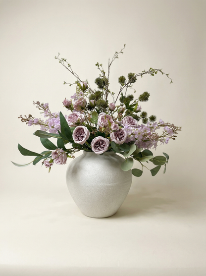 Floral arrangement in a white vase on a light background