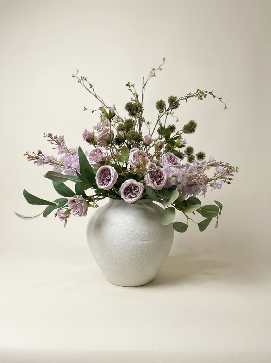 Floral arrangement in a white vase on a light background