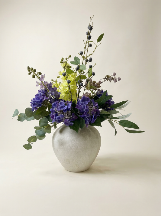 Floral arrangement in a white vase on a light background