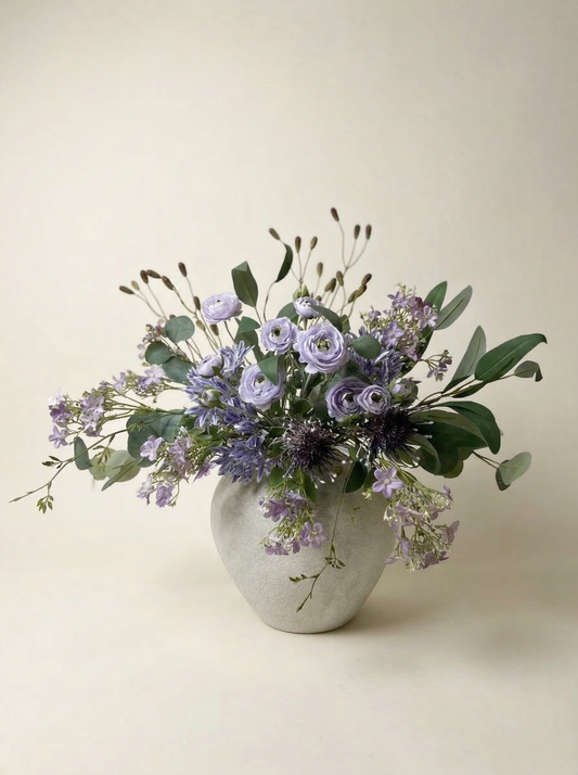 Vase with a bouquet of flowers on a beige background